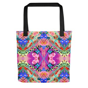 May include: A colorful tote bag with a floral and butterfly pattern. The bag has black straps and a pink, blue, and green background.