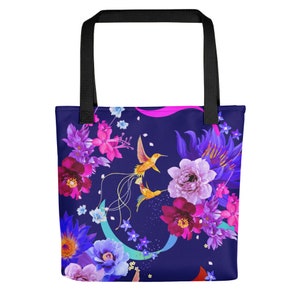 May include: A navy blue tote bag with a floral pattern featuring pink, purple, and blue flowers, and yellow hummingbirds. The bag has black handles.