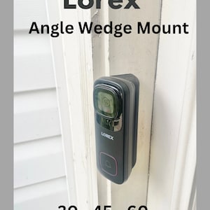 May include: A black Lorex angle wedge mount for a security camera. The mount is designed to adjust the camera's angle to 30, 45, or 60 degrees. The mount is attached to a white wall.