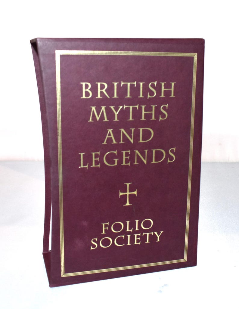 May include: A maroon book titled "British Myths and Legends" with gold lettering and a gold border. The Folio Society logo is at the bottom. The book is in a maroon slipcase.