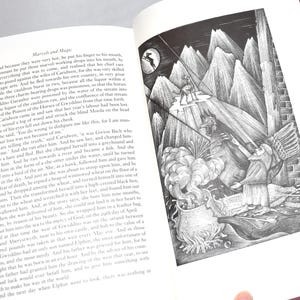 May include: An open book with text and a detailed black and white illustration. The illustration depicts a figure on a mountain peak, with other figures and a cauldron below. The page number 152 is visible.