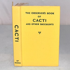 May include: A yellow book titled "The Observer's Book of Cacti and Other Succulents." The spine reads "Cacti" vertically. The book is a vintage edition, with the number "27" and the publisher "Warne" visible.