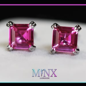 May include: A pair of square-cut, bright pink gemstone stud earrings with silver-colored settings. The earrings are set against a white background, with the brand name "MINX LONDON" displayed below.