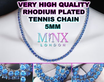 May include: A silver tennis chain necklace with blue stones. The chain is 5mm wide and is rhodium plated. The necklace is from the brand Minx London.