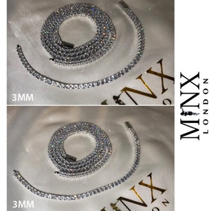 May include: Two silver chains with clear cubic zirconia stones. The chains are 3mm wide and are laid out on a white surface. The text "MINX LONDON" is visible in the upper right corner of the image.