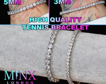May include: Two silver tennis bracelets with clear cubic zirconia stones. The bracelet on the left is 5mm wide and the bracelet on the right is 3mm wide.  HIGH QUALITY TENNIS BRACELET. MINX LONDON.