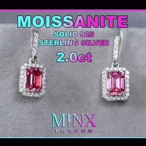 May include: A pair of pink moissanite earrings with a square emerald cut stone set in a halo of smaller stones. The earrings are made of solid 925 sterling silver and are 2.0ct in size. The earrings are shown against a grey background with the text "MOISSANITE SOLID 925 STERLING SILVER 2.0ct MINX LONDON" visible.