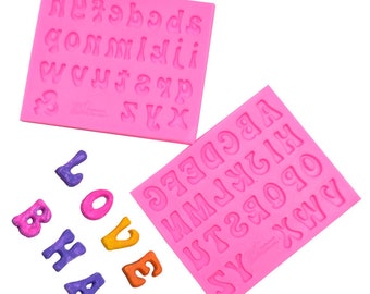 May include: Two pink silicone alphabet molds with uppercase letters. The molds are on a white background. There are also several colorful letters made from the molds.