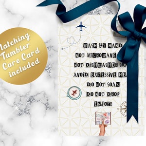 May include: A white card with a gold geometric pattern and travel-themed illustrations. The card includes care instructions for a tumbler: "Wash by hand, not microwave, not dishwasher safe, avoid excessive heat, do not soak, do not drop, enjoy!"