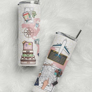May include: Two stainless steel travel tumblers with a travel theme. One tumbler features a pink world map with a compass, suitcases, and a hat. The other tumbler features a map of Berlin, a plane, and a camera.