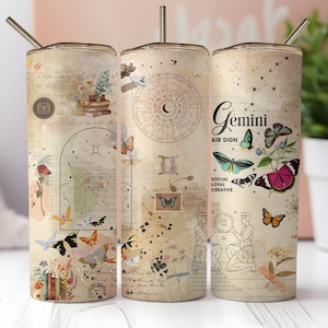 Puede incluir: Un vaso de acero inoxidable con un estilo vintage que presenta el signo del zodíaco Géminis, mariposas y elementos florales. El vaso tiene una tapa y una pajita doradas. El texto "Géminis Signo de Aire Social Leal Creativo" está impreso en el vaso.