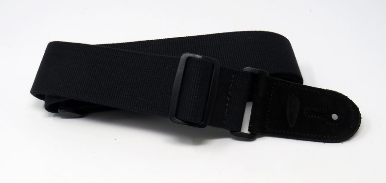 May include: Black guitar strap with a black leather end and a black metal buckle.