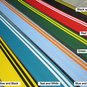 May include: Five different colored fabric ribbon trims with two contrasting stripes. The colors are yellow and black, teal and white, blue and orange, green and yellow, and red and white.