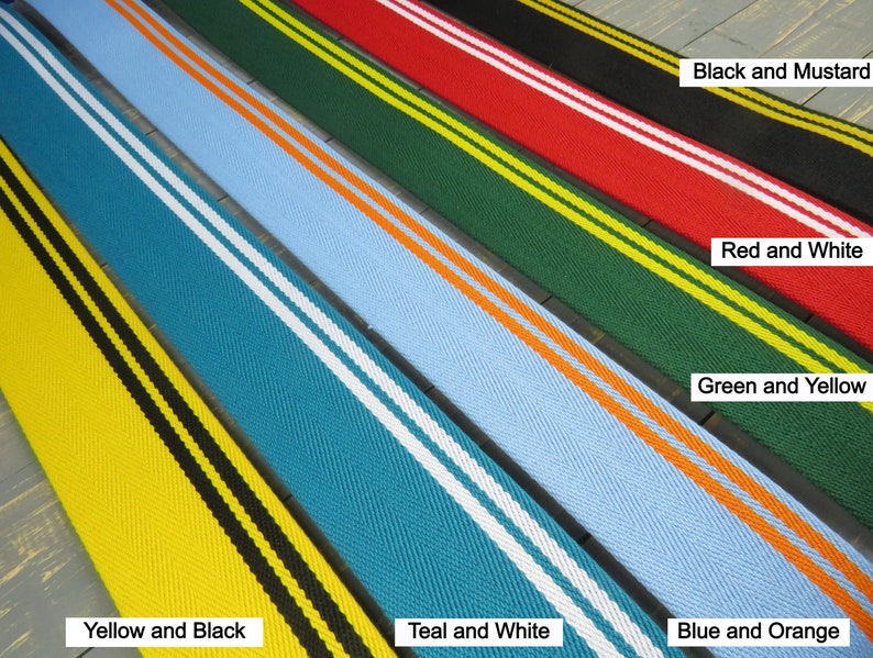 May include: Five different colored fabric ribbon trims with two contrasting stripes. The colors are yellow and black, teal and white, blue and orange, green and yellow, and red and white.