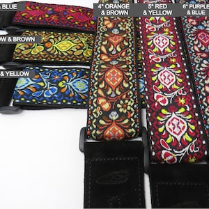 May include: Six guitar straps with different colored embroidered patterns. The straps are labeled with numbers and colors, such as "1* Red & Blue", "2* Yellow & Brown", "3* Blue & Yellow", "4* Orange & Brown", "5* Red & Yellow", and "6* Purple & Blue".