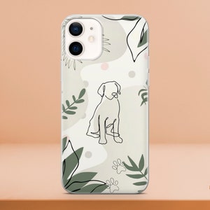 May include: Clear phone case featuring a line drawing of a dog. The design includes green leaves, paw prints, and abstract shapes on a light background. The case is designed to fit a smartphone.