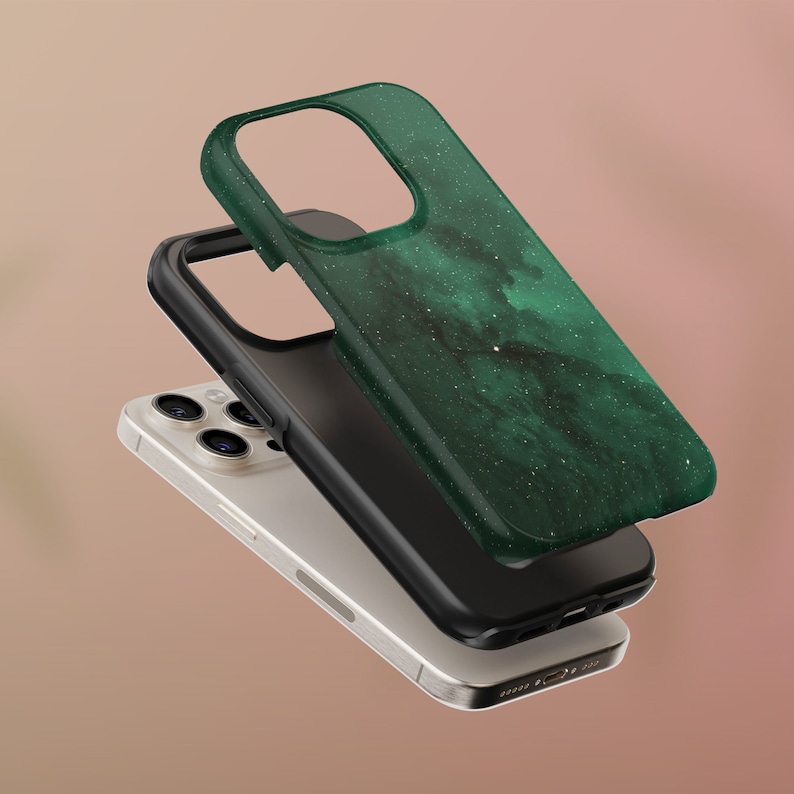 May include: A layered image of a smartphone with a green and black case. The top case has a dark green, marbled design with white speckles. The middle layer is a black case, and the phone itself is silver.
