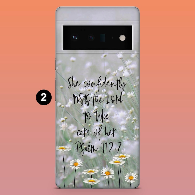 May include: A phone case featuring a floral design with white daisies and green stems. The case has the text "She confidently trusts the Lord to take care of her. Psalm 112:7" in a handwritten style.
