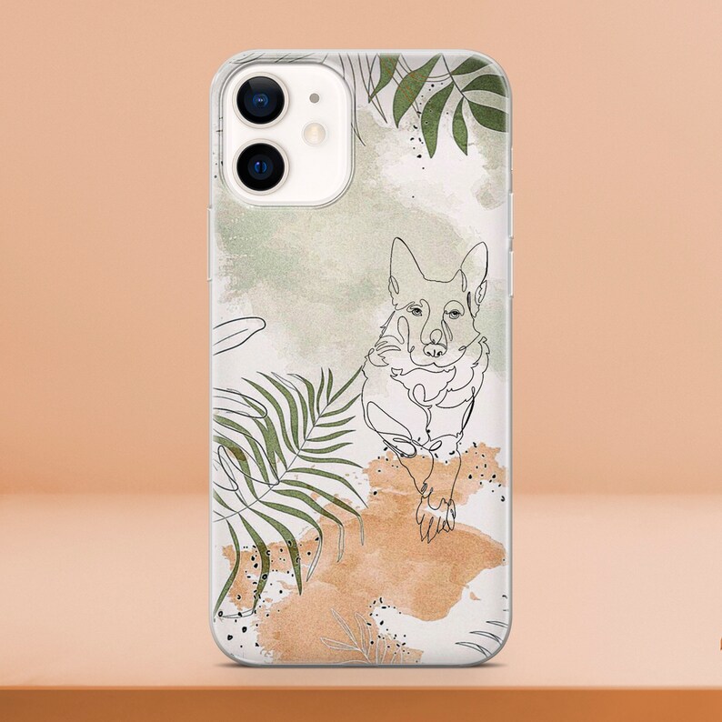 May include: Clear phone case featuring a line drawing of a dog with green leaf accents and a watercolor background in shades of green and brown. The case is designed for a smartphone.