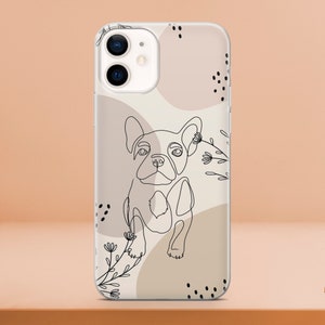 May include: Clear phone case featuring a line drawing of a French Bulldog. The design includes abstract shapes in beige and brown, with black floral accents and dots. The case is designed for an iPhone.