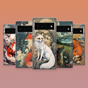 May include: Five phone cases with fox illustrations in various styles. The cases feature detailed artwork of foxes in different settings, including a white fox under a full moon and a red fox in a snowy landscape. The cases have a sleek, modern design.