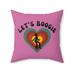 May include: Pink throw pillow with the text "Let's Boogie" in black, featuring a silhouette of a person dancing inside a multi-colored heart.