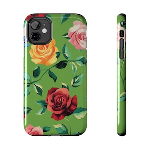 May include: A green phone case with a floral pattern featuring red, yellow, and pink roses. The case has a cutout for the camera lens.