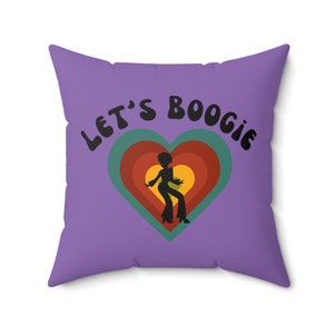 May include: Purple throw pillow with the text "Let's Boogie" in black, featuring a silhouette of a person dancing inside a multi-colored heart.