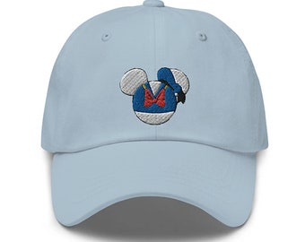 May include: A light blue baseball cap with an embroidered image of Donald Duck's head in a Mickey Mouse silhouette.