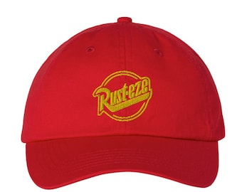 May include: A red baseball cap with a gold embroidered logo that says "Rust-eze".