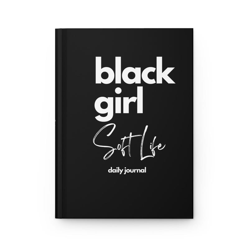May include: Black journal with the text "black girl soft life daily journal" in white.