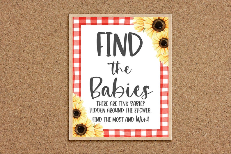 May include: A white sign with red and white checkered border and sunflowers. The sign says "FIND the Babies" and "THERE ARE TINY BABIES HIDDEN AROUND THE SHOWER. FIND THE MOST AND Win!"