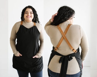 Customizable cross back apron with adjustable vegan leather straps.