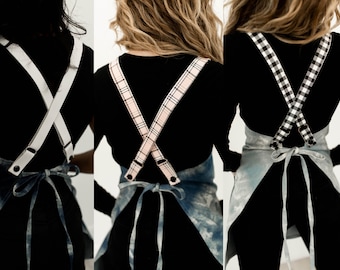 Customizable cross back apron with adjustable vegan leather straps.