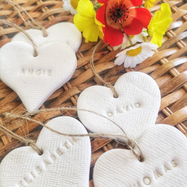 Personalized clay wedding favors | handmade gauze textured name tags | ceramic wedding place tags | heart shaped keepsakes