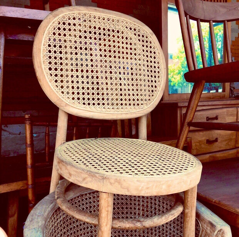 May include: A wooden chair with a woven cane seat and back. The chair has a rounded back and a simple design.