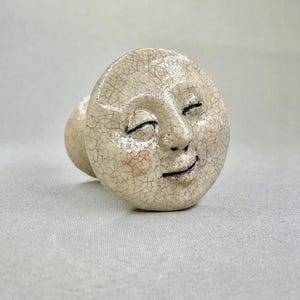 May include: A set of three ceramic mugs with a speckled, matte finish in cream, light grey, and dark grey. Each mug has a simple, minimalist design, suitable for coffee or tea.