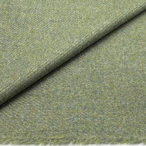 May include: A close-up shot of a folded fabric in shades of green and grey. The material has a woven pattern and a slightly frayed edge. The fabric appears soft and is suitable for clothing or home decor.