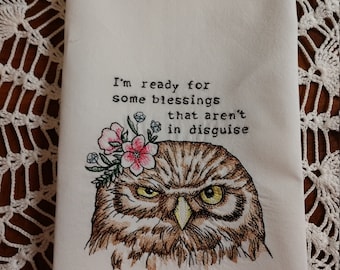 May include: Embroidered kitchen towel with an owl wearing a flower crown. The text reads "I'm ready for some blessings that aren't in disguise."