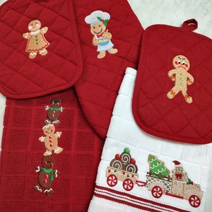 May include: Set of four red and white kitchen towels with gingerbread man and woman embroidery. The towels feature a variety of designs, including a gingerbread man holding a rolling pin, a gingerbread woman holding a cookie, a gingerbread man holding a tree, and a gingerbread man holding a wagon full of cookies.