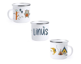 May include: Three white enamel mugs with different designs. The first mug has a bear, trees, and an owl. The second mug has the name "Linus" written on it. The third mug has a fox, a raccoon, and two tents.