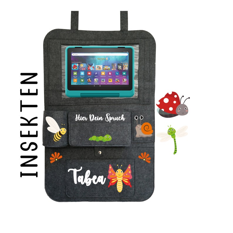 May include: Gray felt car seat organizer with a clear plastic window for a tablet. The organizer has pockets for storage and features embroidered insects, a caterpillar, and the name "Tabea".