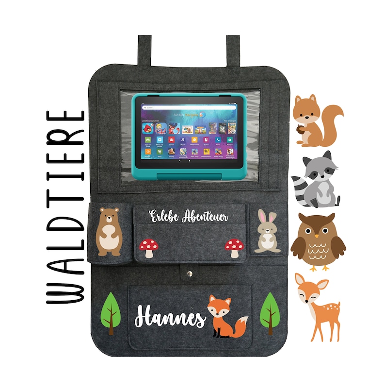 May include: Gray felt car seat organizer with pockets and a clear window for a tablet. The organizer has a white inscription that says "Erlebe Abenteuer" and "Hannes". The organizer has several colorful animal illustrations, including a squirrel, raccoon, owl, deer, bear, and fox.
