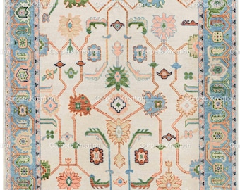 May include: A traditional rug with a cream background and a blue, green, pink, and orange geometric pattern. The rug has a border with a light blue background and a geometric pattern.