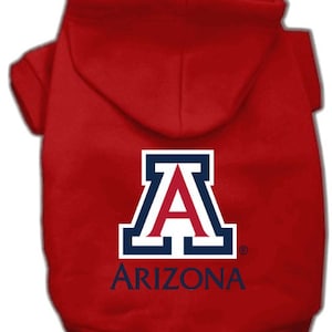 Peut inclure: Sweat-shirt à capuche rouge pour animal de compagnie avec le logo de l'Université d'Arizona et le mot "ARIZONA" imprimé au dos.