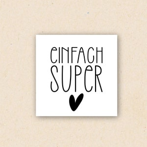 May include: White card with black text that reads "Einfach Super" with a black heart below the text.