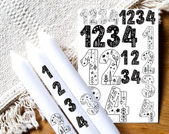 May include: Three white candles with black and white numbers 1, 2, 3, and 4 printed on them. A sheet of stickers with black and white numbers 1, 2, 3, and 4 with a woodland theme.
