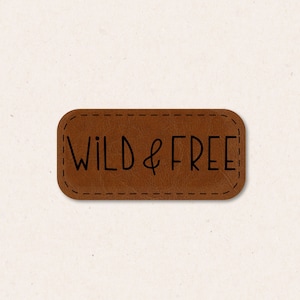 May include: Brown leather patch with a stitched border and the text "WILD & FREE" in black.