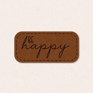 May include: Brown leather patch with a stitched border and the text "BE happy" in black script.
