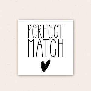 May include: White card with black text that reads "PERFECT MATCH" with a black heart below the text.